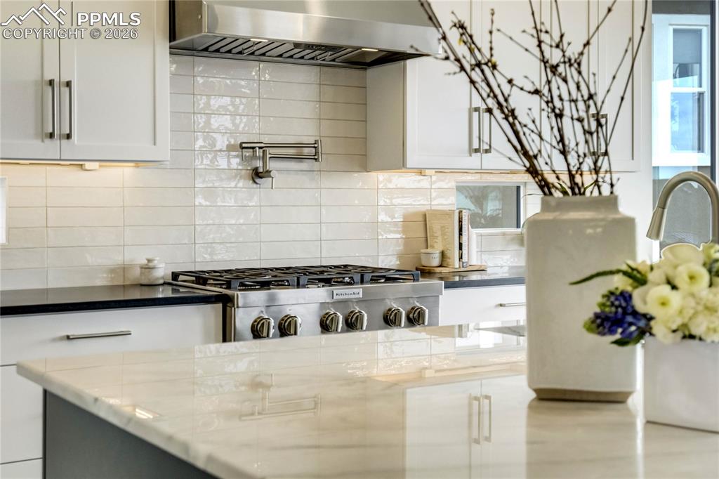 Image 10 of 50: The KitchenAid Gas Range w/Pot Filler Above Stands Ready for Elevated Culin