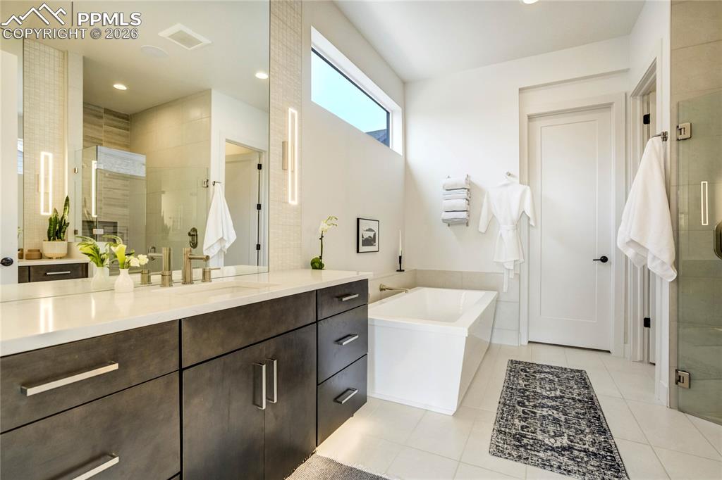 Image 19 of 50: Dual Vanities Finished in Calacatta Lavasa Quartz are Wrapped in Counter-to