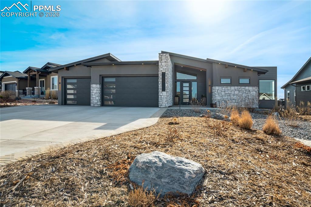 Image 2 of 50: Stone and stucco architecture rise against Colorado sky, blending modern li