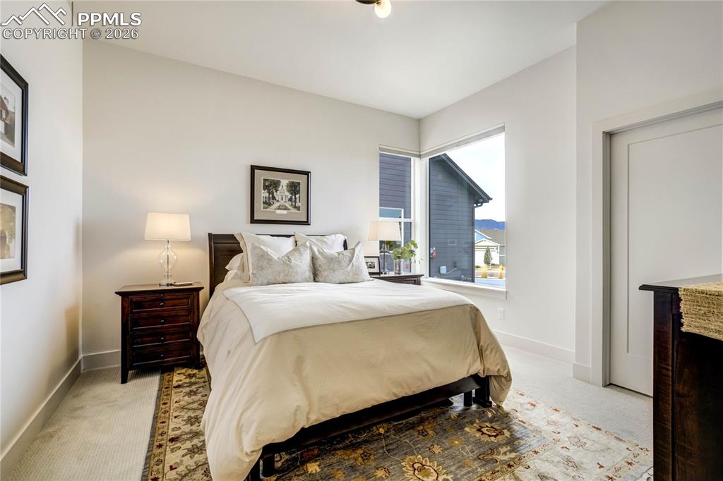 Image 24 of 50: Secondary Main Level Bedroom: Ideally Positioned on the Main Level, This Li