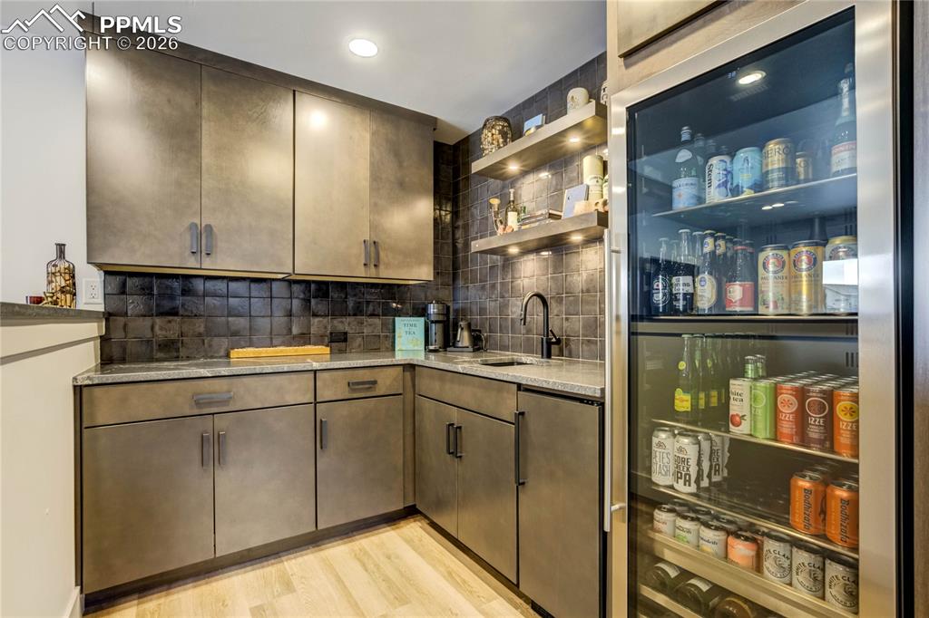 Image 29 of 50: Thoughtfully Designed for Elevated Entertaining, the Bar Features Honed Bla