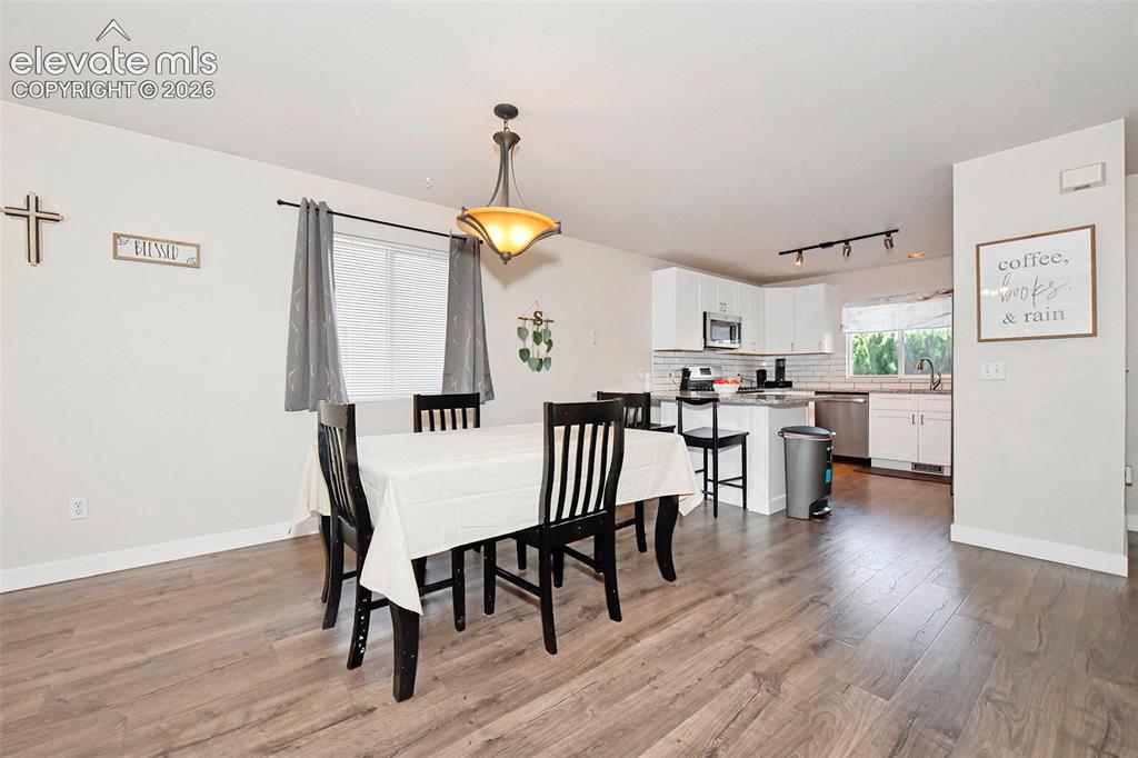 Image 10 of 26: Dining area near kitchen.