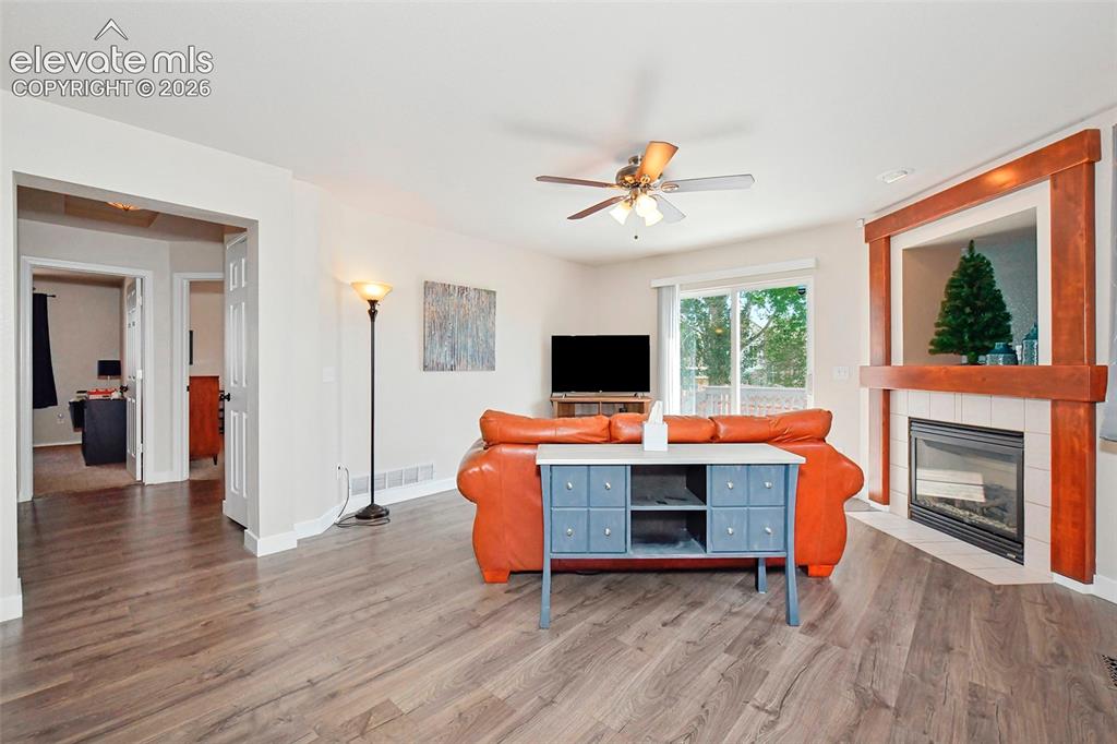 Image 14 of 26: Living room with view of hallway to 2 bedrooms and main level bath.
