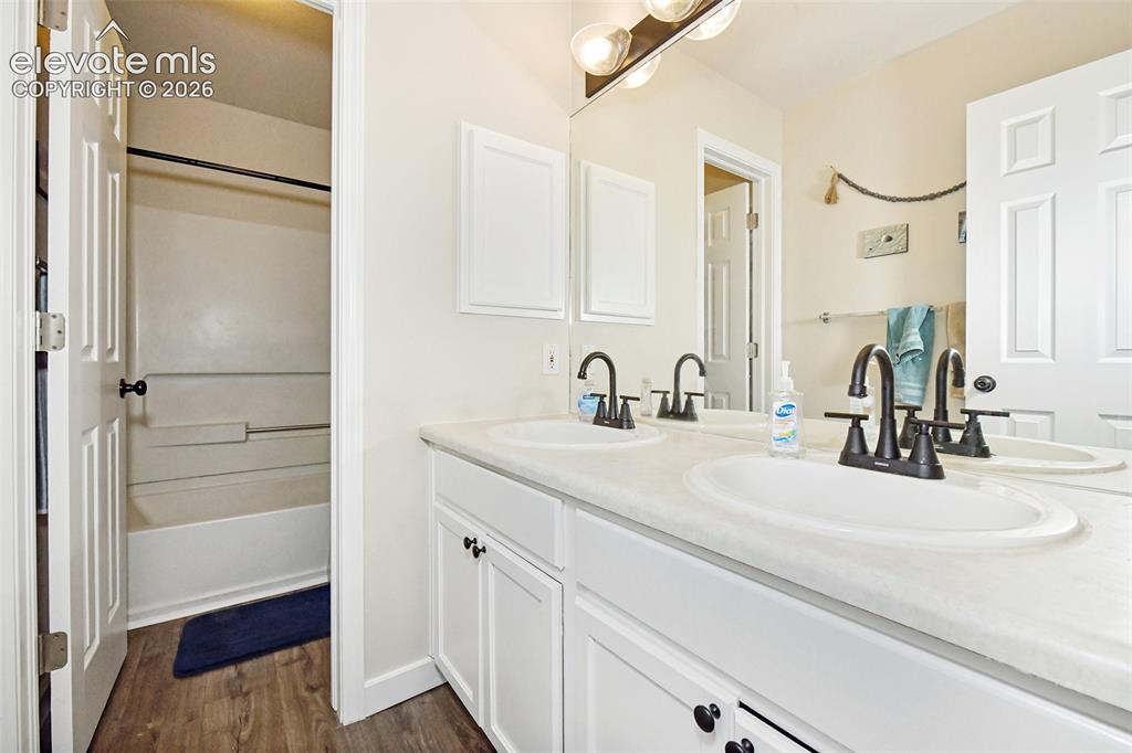 Image 18 of 26: Main level bathroom with separate toilet/tub combo.