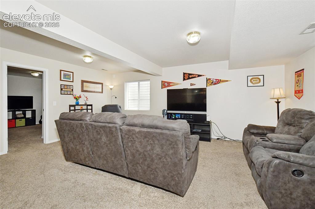 Image 21 of 26: Large room with bedrooms to the left.