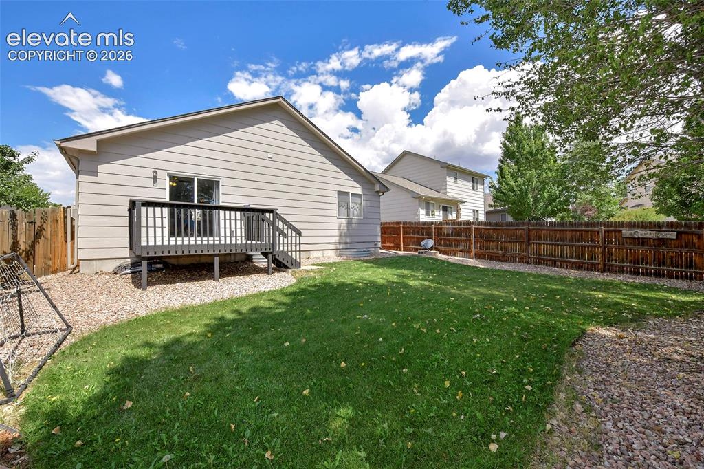 Image 4 of 26: View of back entrance and deck.