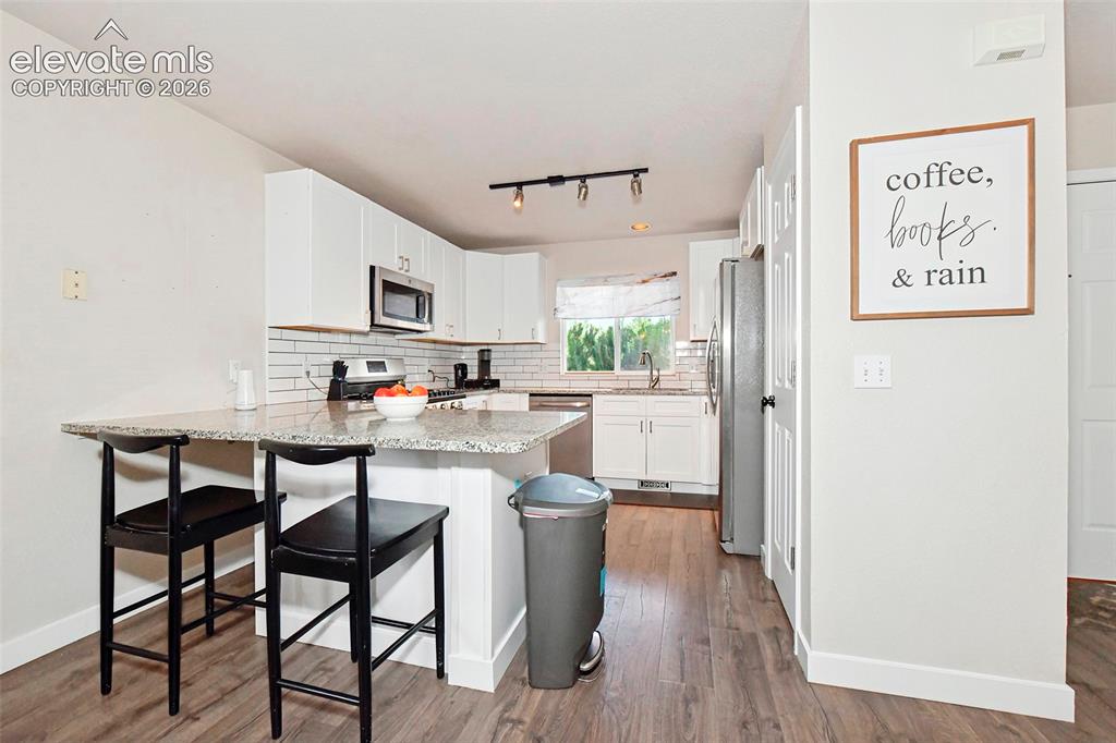 Image 8 of 26: New cabinets, granite, and microwave in 2021. Other appliances new in 2020
