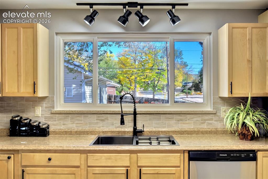 Image 15 of 50: Kitchen featuring light-finish cabinetry, neutral stone-composite counterto
