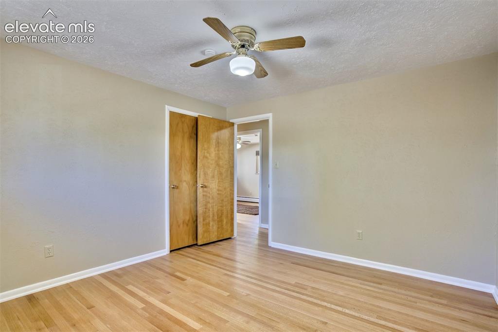 Image 24 of 50: Room featuring wood-finish flooring, neutral wall paint, and a ceiling-moun