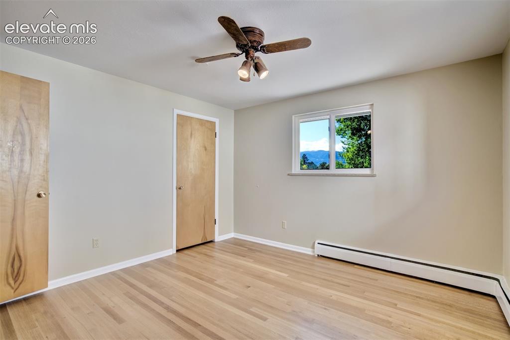Image 26 of 50: Interior space featuring wood-finish flooring, natural wood doors, ceiling