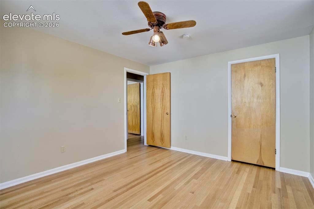 Image 27 of 50: Interior space featuring wood-finish flooring, neutral wall tones, flat-pan