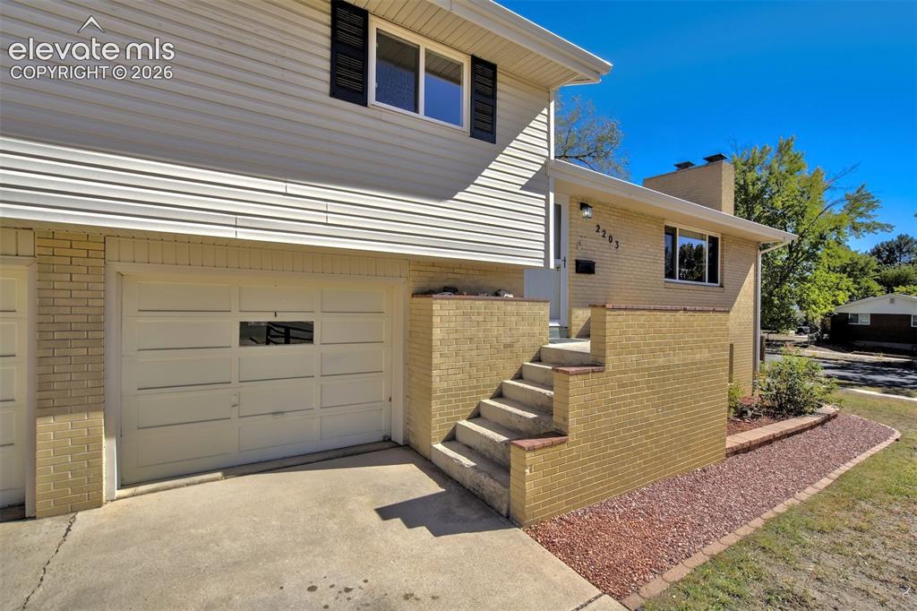 Image 4 of 50: Modern two-story residence featuring a double-car garage with paneled doors