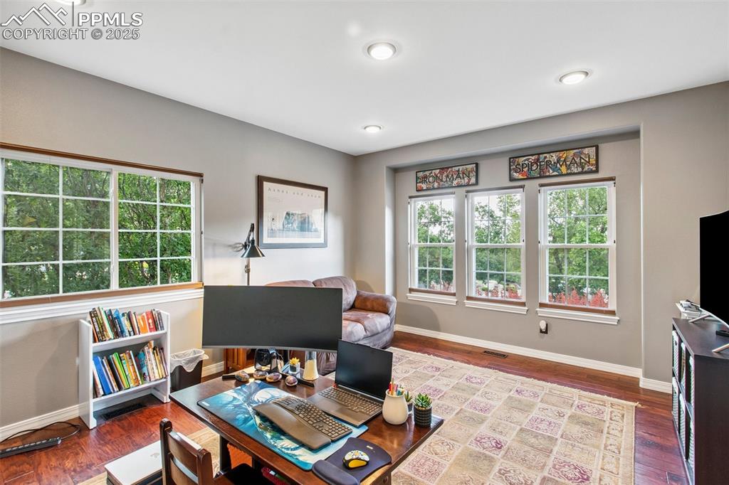 Image 15 of 44: Office area with baseboards and wood finished floors