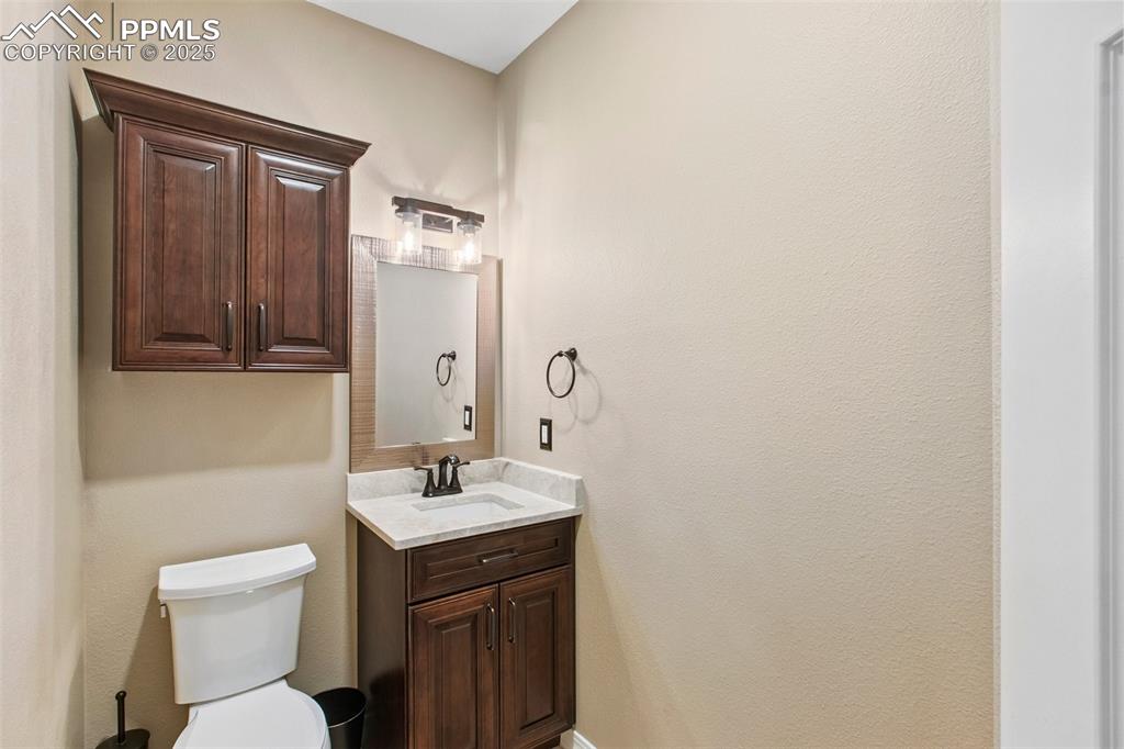Image 17 of 44: Half bathroom featuring vanity and toilet