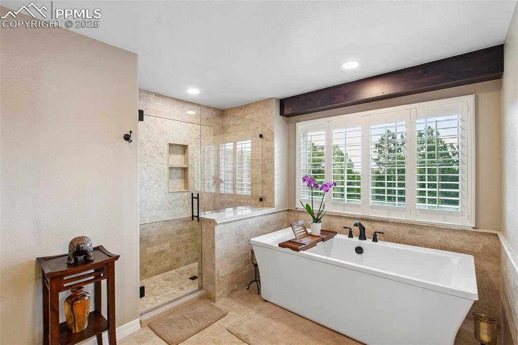Image 22 of 44: Full bath with a shower stall, a freestanding tub, tile patterned floors, t