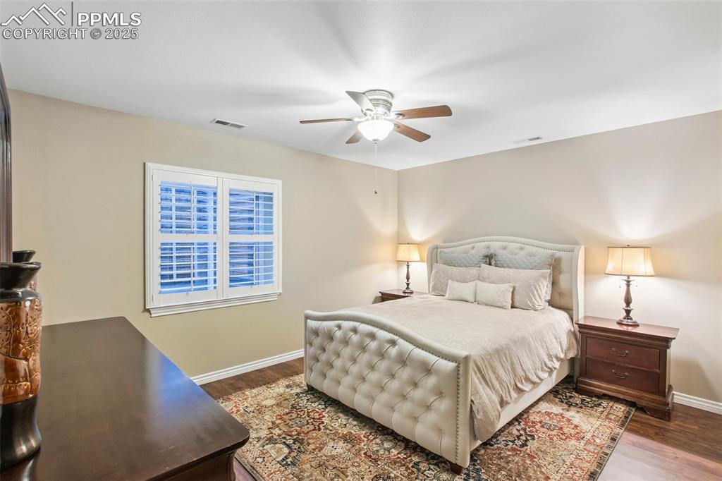 Image 28 of 44: Bedroom featuring wood finished floors and ceiling fan