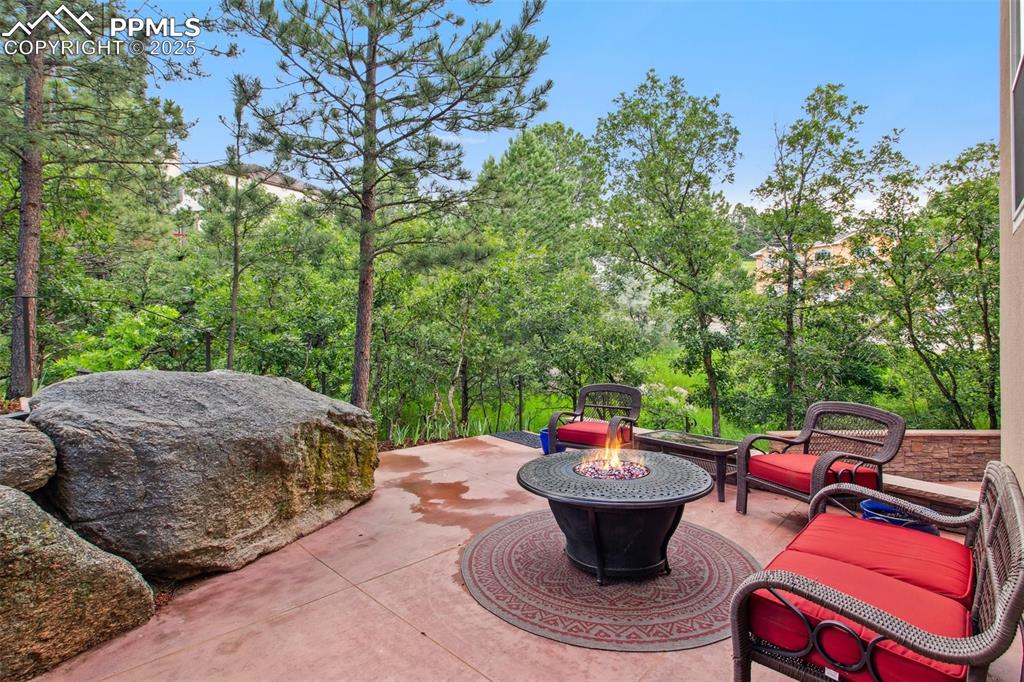 Image 39 of 44: View of patio with a fire pit