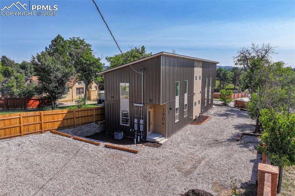 Caption: View of outdoor structure featuring a fenced backyard