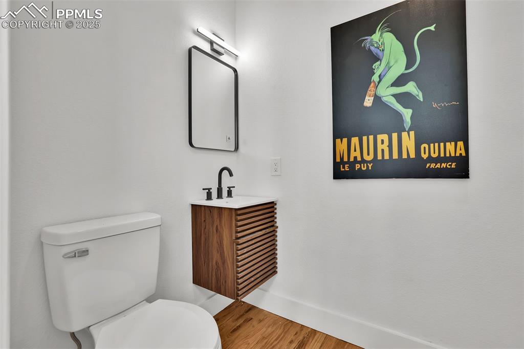 Image 13 of 49: Bathroom featuring wood finished floors and vanity