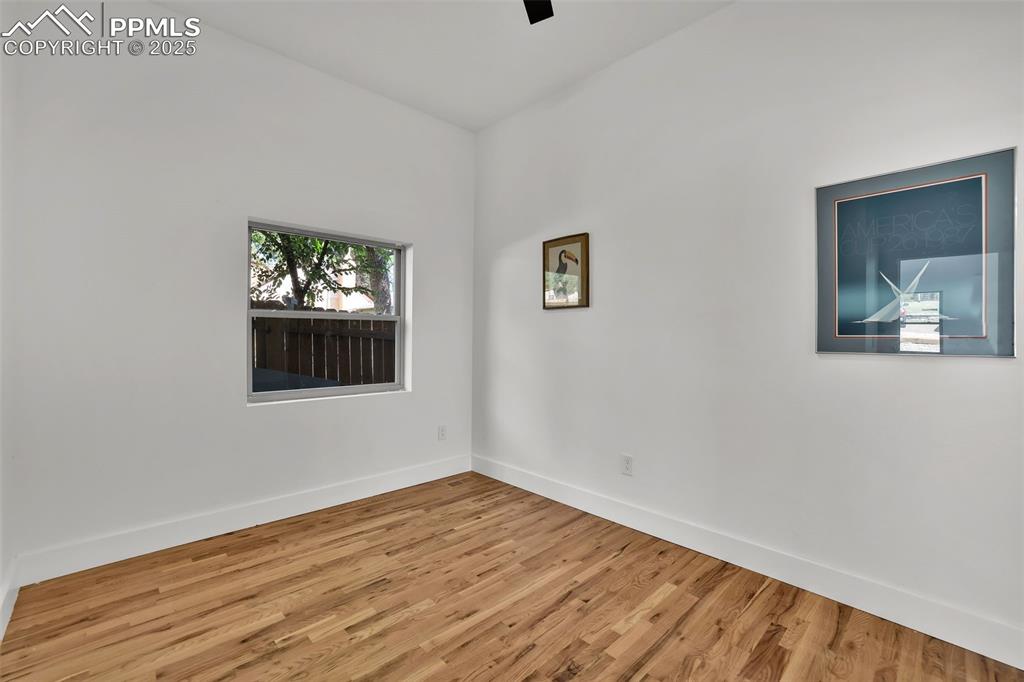 Image 15 of 49: Spare room featuring wood finished floors and baseboards