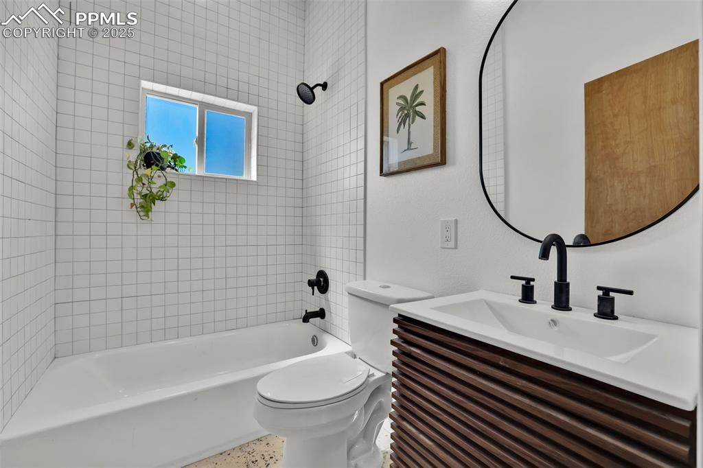 Image 18 of 49: Full bath featuring washtub / shower combination and vanity