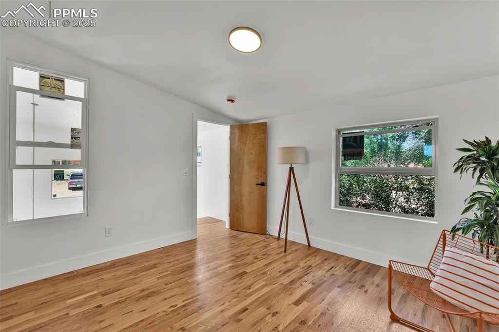 Image 21 of 49: Unfurnished room featuring wood finished floors and baseboards