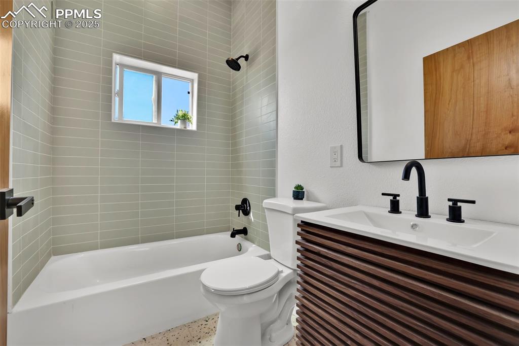 Image 22 of 49: Bathroom with shower / bathtub combination and vanity