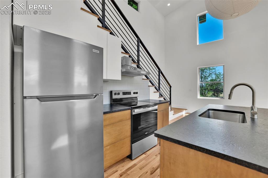 Image 30 of 49: Kitchen with healthy amount of natural light, appliances with stainless ste