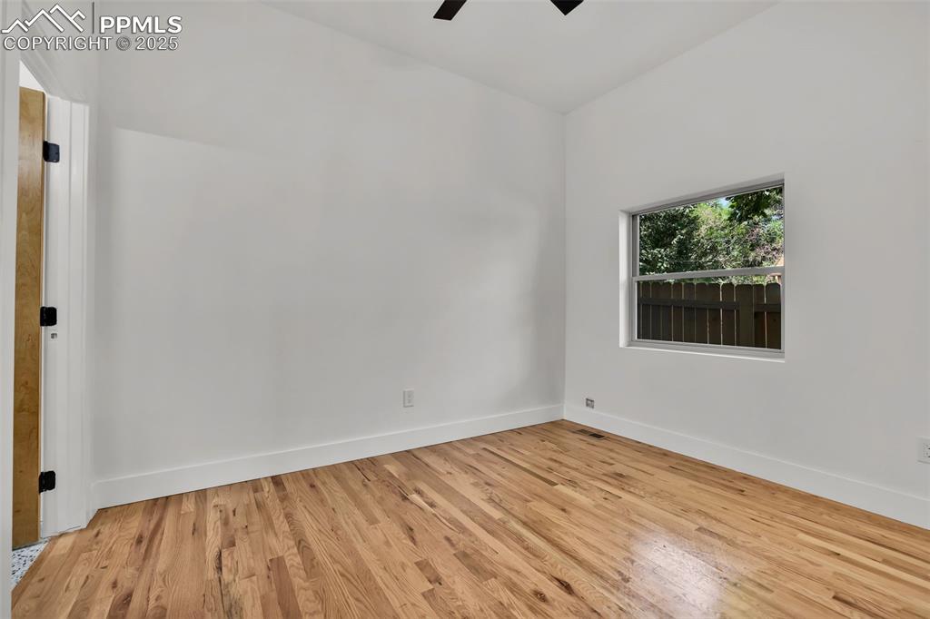 Image 37 of 49: Spare room featuring light wood-style floors and a ceiling fan
