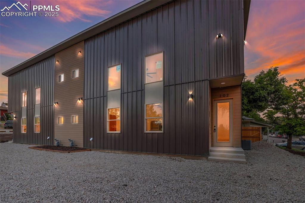 Image 47 of 49: Back of property with board and batten siding