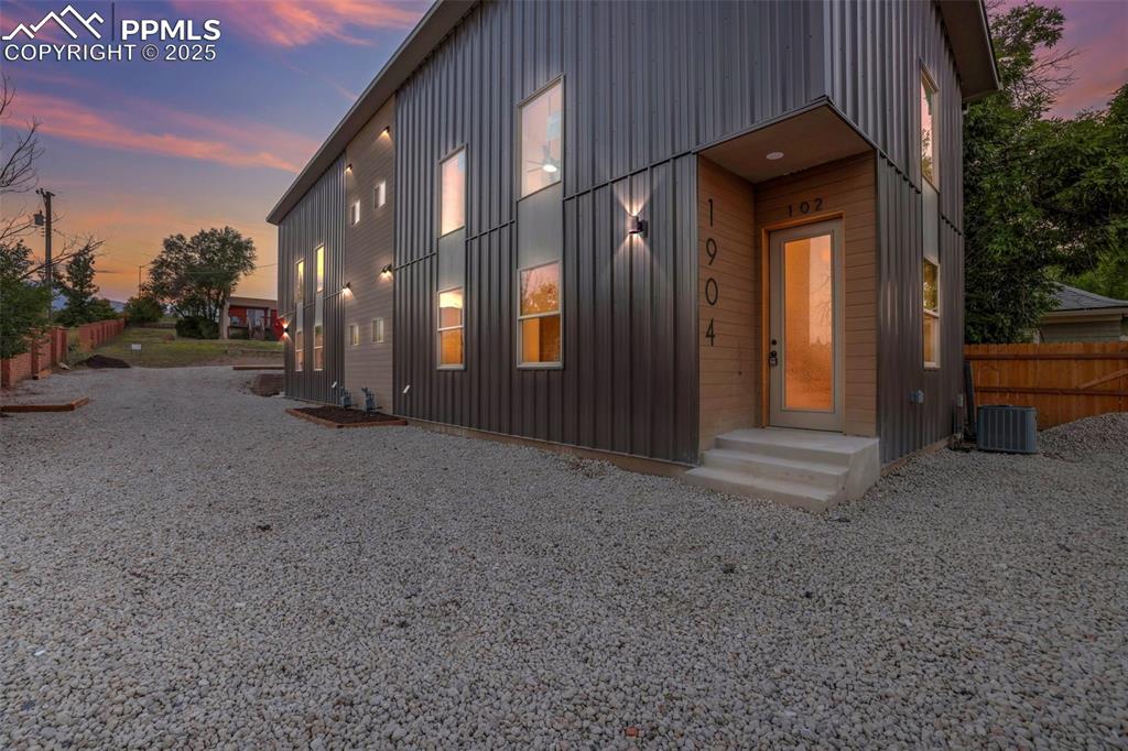 Image 48 of 49: View of front of home with board and batten siding