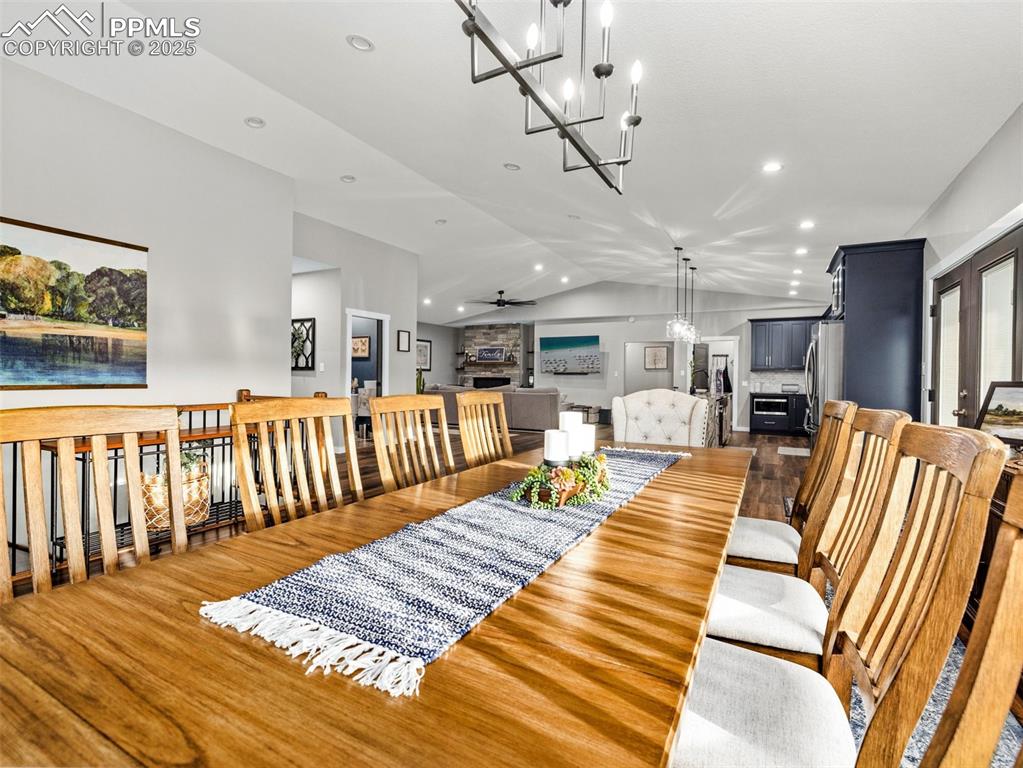 Image 13 of 48: Dining space with wood finished floors, lofted ceiling, recessed lighting, 