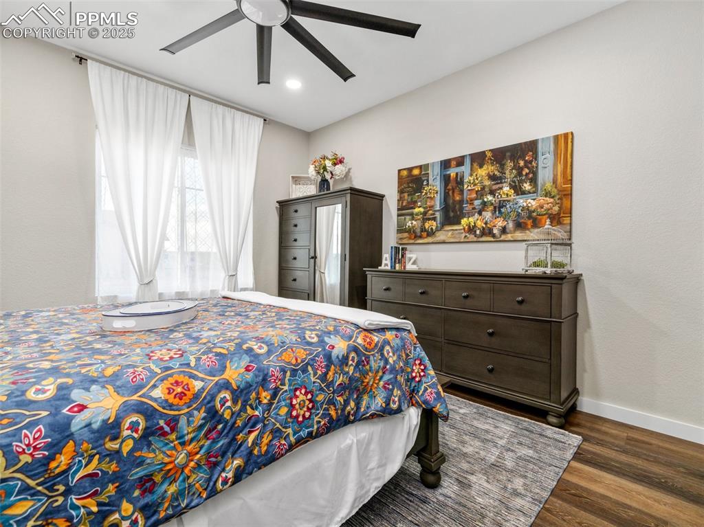 Image 29 of 48: Bedroom featuring wood finished floors, ceiling fan, and recessed lighting