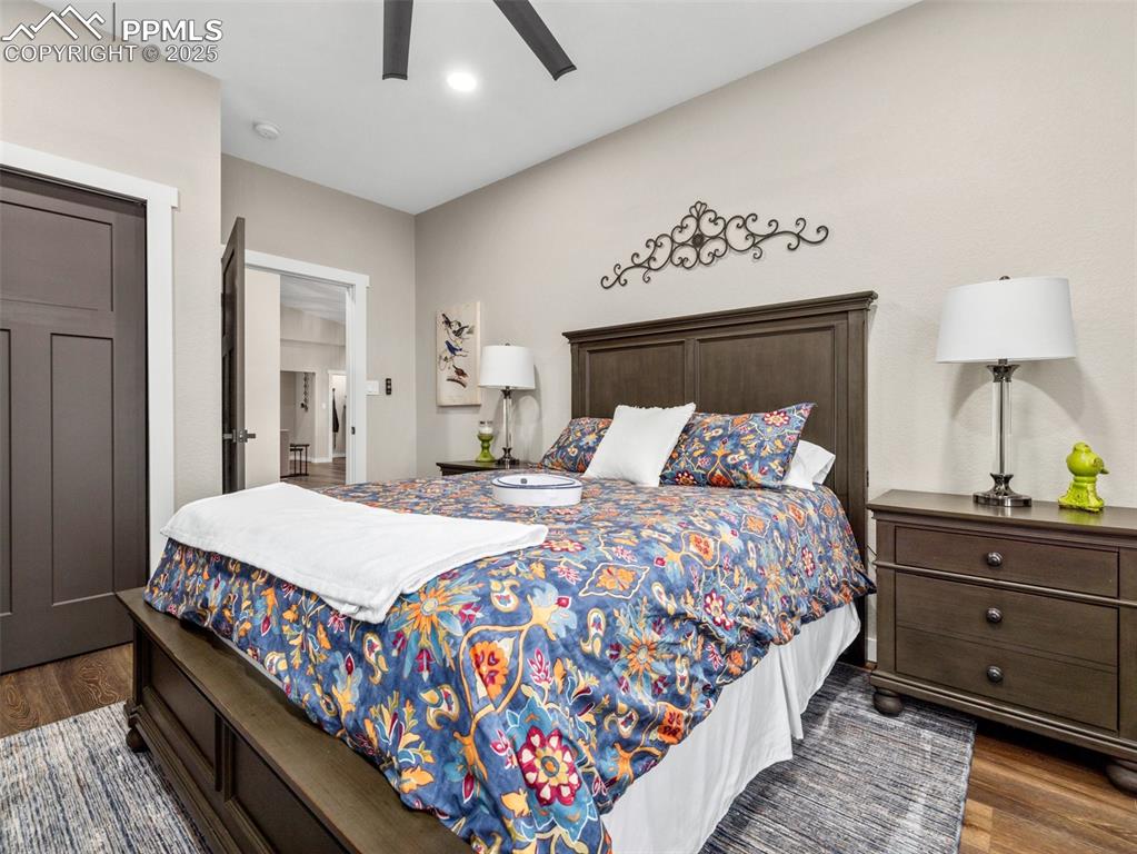 Image 30 of 48: Bedroom with dark wood-type flooring and ceiling fan