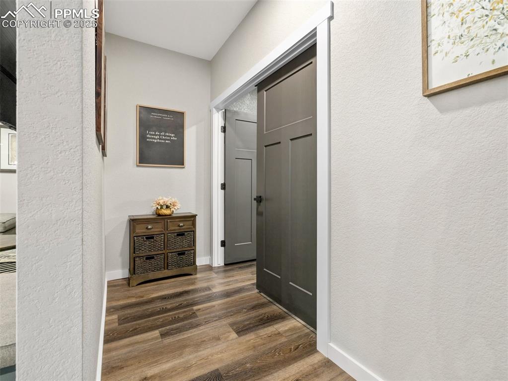 Image 31 of 48: Hall featuring dark wood-style floors and baseboards