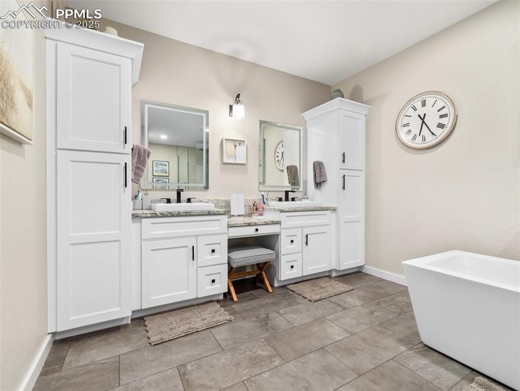 Image 34 of 48: Full bathroom featuring double vanity and a freestanding bath