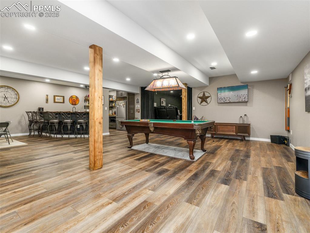 Image 38 of 48: Rec room featuring wood finished floors, pool table, recessed lighting, and