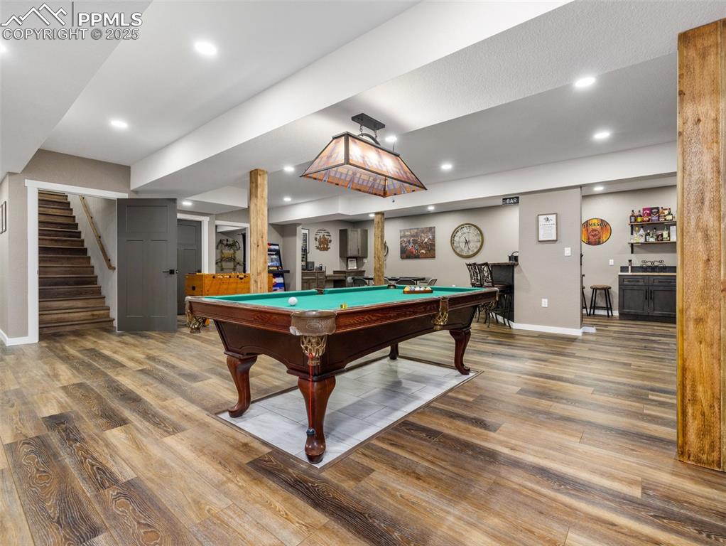 Image 39 of 48: Game room with pool table, wood finished floors, a dry bar, and recessed li