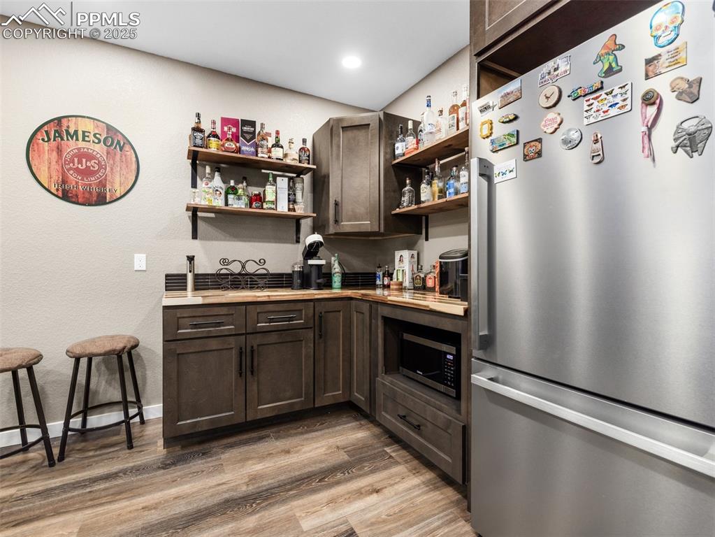 Image 42 of 48: Kitchen featuring appliances with stainless steel finishes, open shelves, d