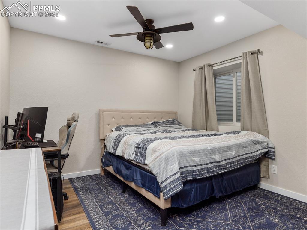 Image 48 of 48: Bedroom featuring recessed lighting, a ceiling fan, and wood finished floor