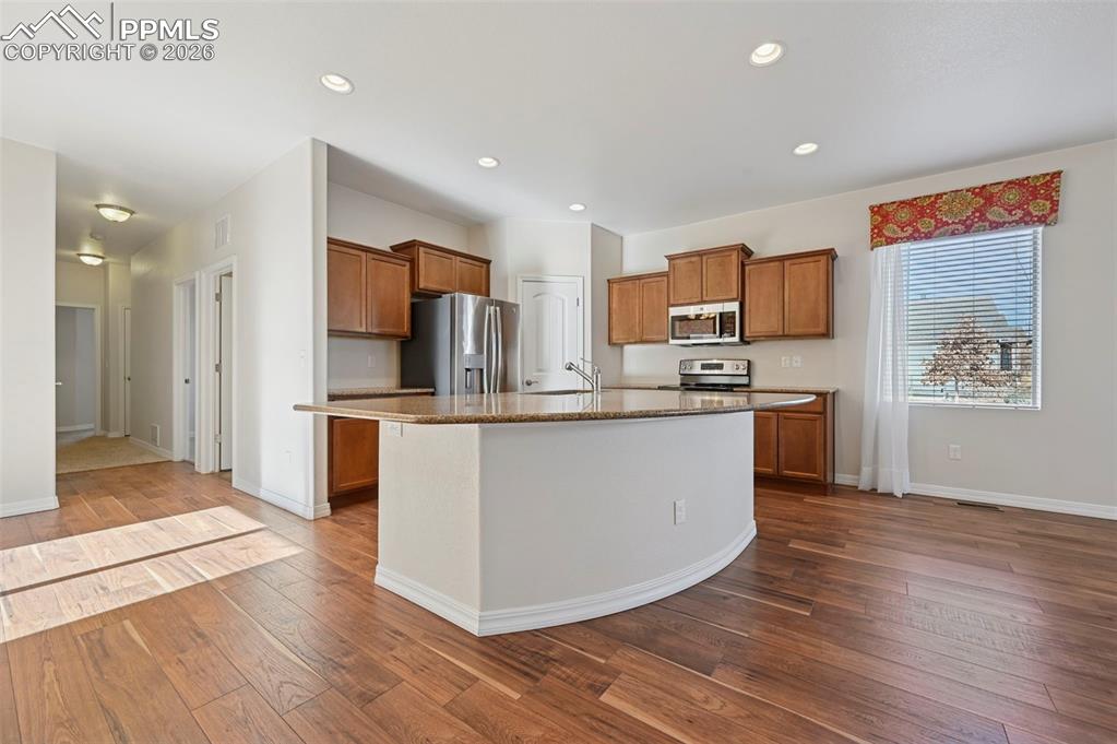 Image 14 of 41: Kitchen with pantry. Space for seating at the island.
