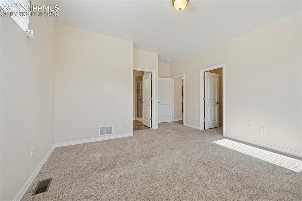 Image 20 of 41: Primary private bath and walk-in closet