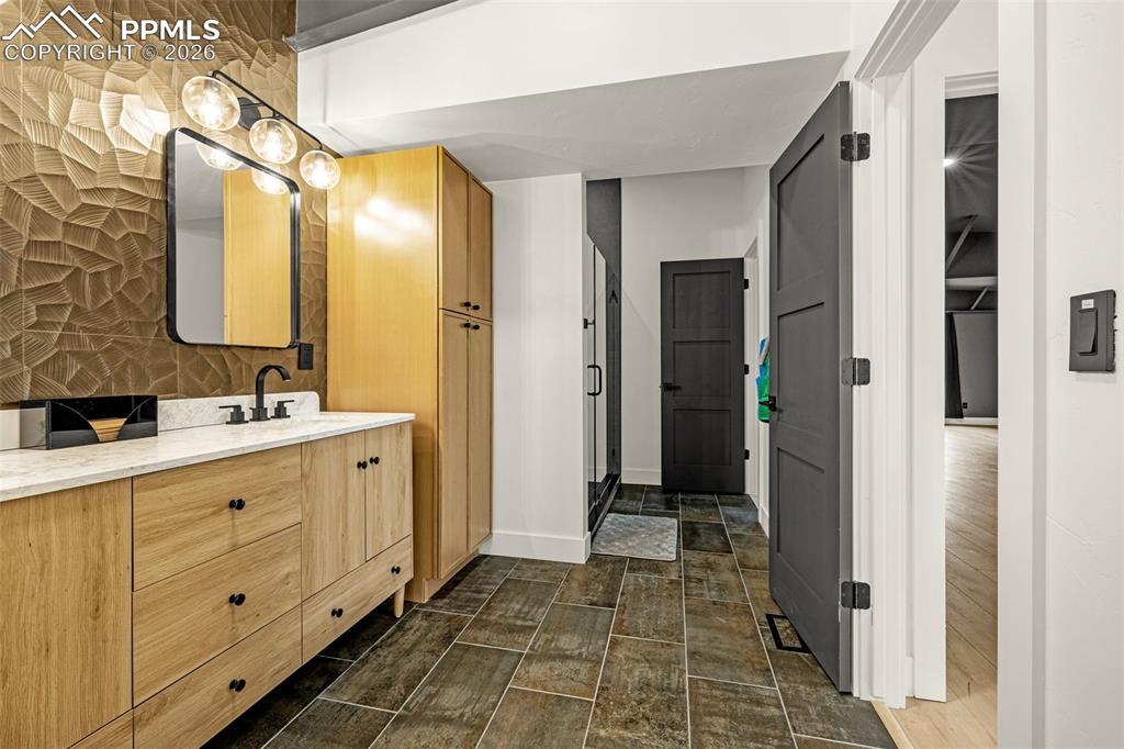 Image 40 of 50: Primary bathroom with entrance from primary bedroom and sun room. Upper Lev