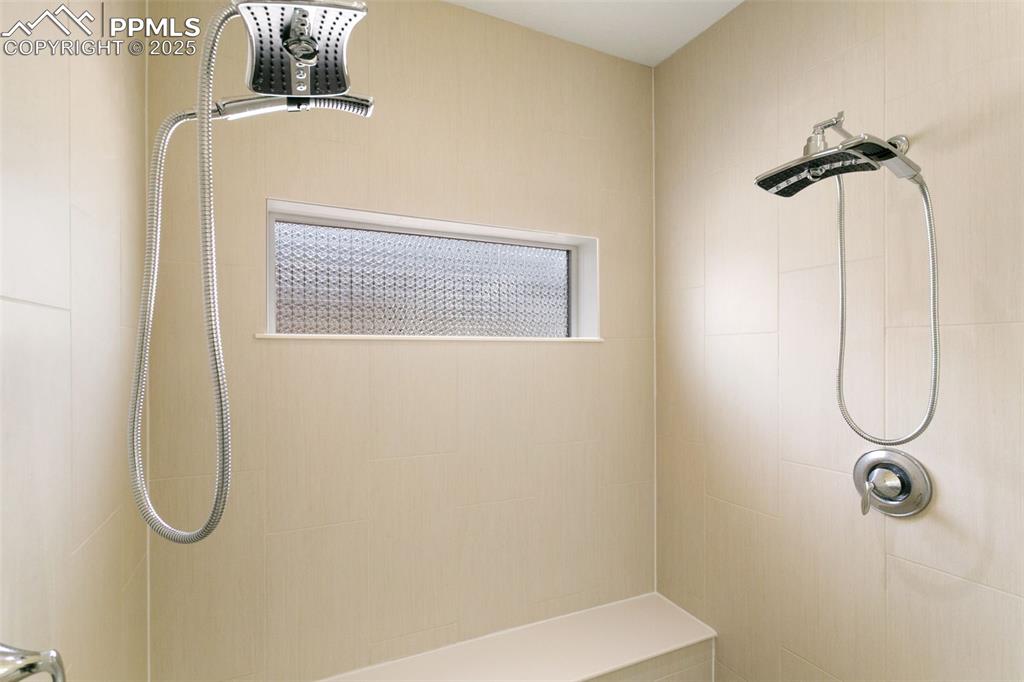 Image 10 of 49: Full bath with tiled zero entry shower and dual heads