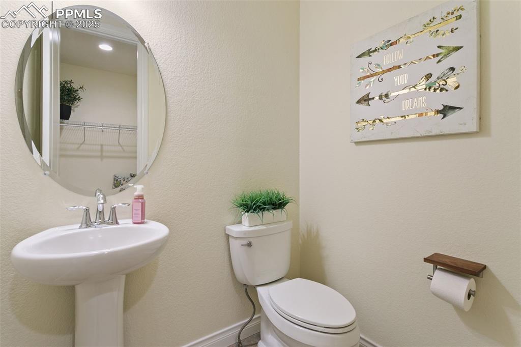 Image 13 of 49: Half bathroom featuring a textured wall