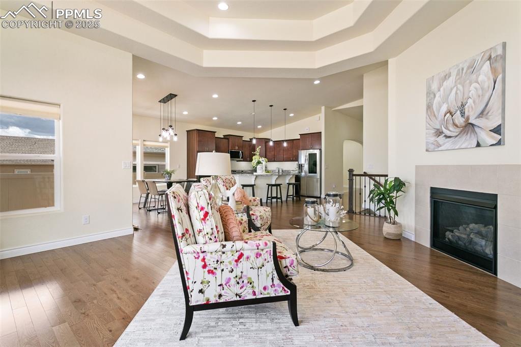 Image 21 of 49: Living area with recessed lighting, a tile fireplace, dark wood finished fl