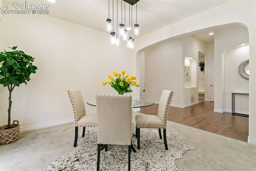 Image 23 of 49: Dining space featuring recessed lighting, a chandelier, and arched walkways