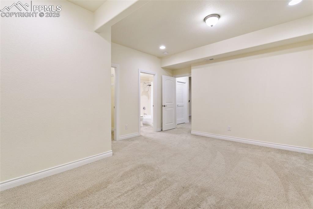 Image 28 of 49: Carpeted junior suite with baseboards and recessed lighting