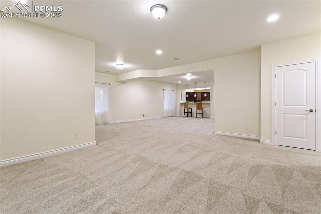 Image 32 of 49: Empty room featuring recessed lighting and light carpet