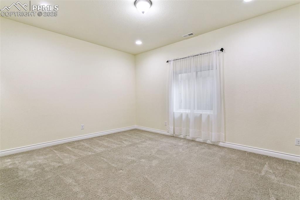 Image 35 of 49: Carpeted 5th bedroom featuring baseboards and recessed lighting